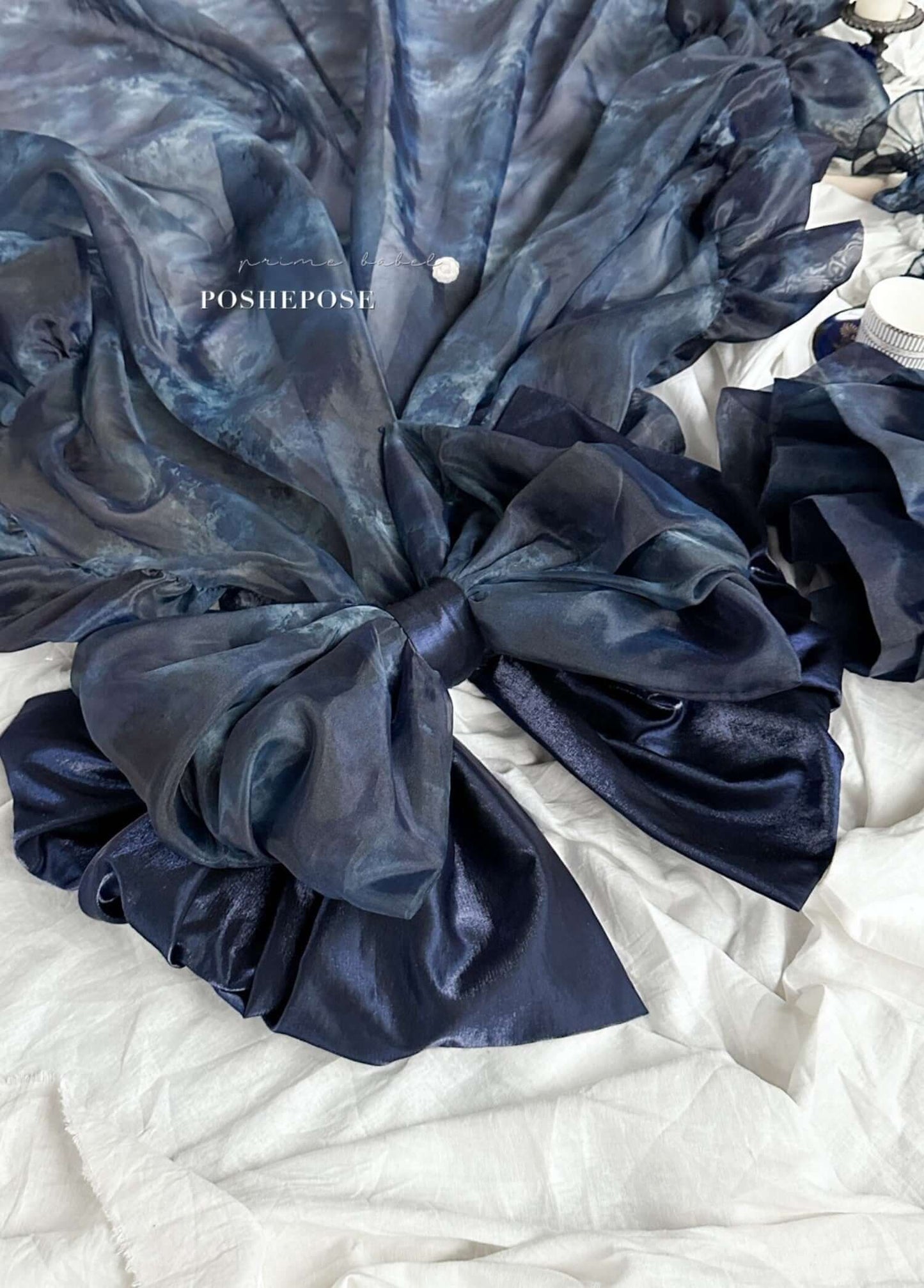 Haute Couture Deep Sea Dress Limited Edition featuring dark, ethereal fabric and a dramatic bow for elegant occasions.