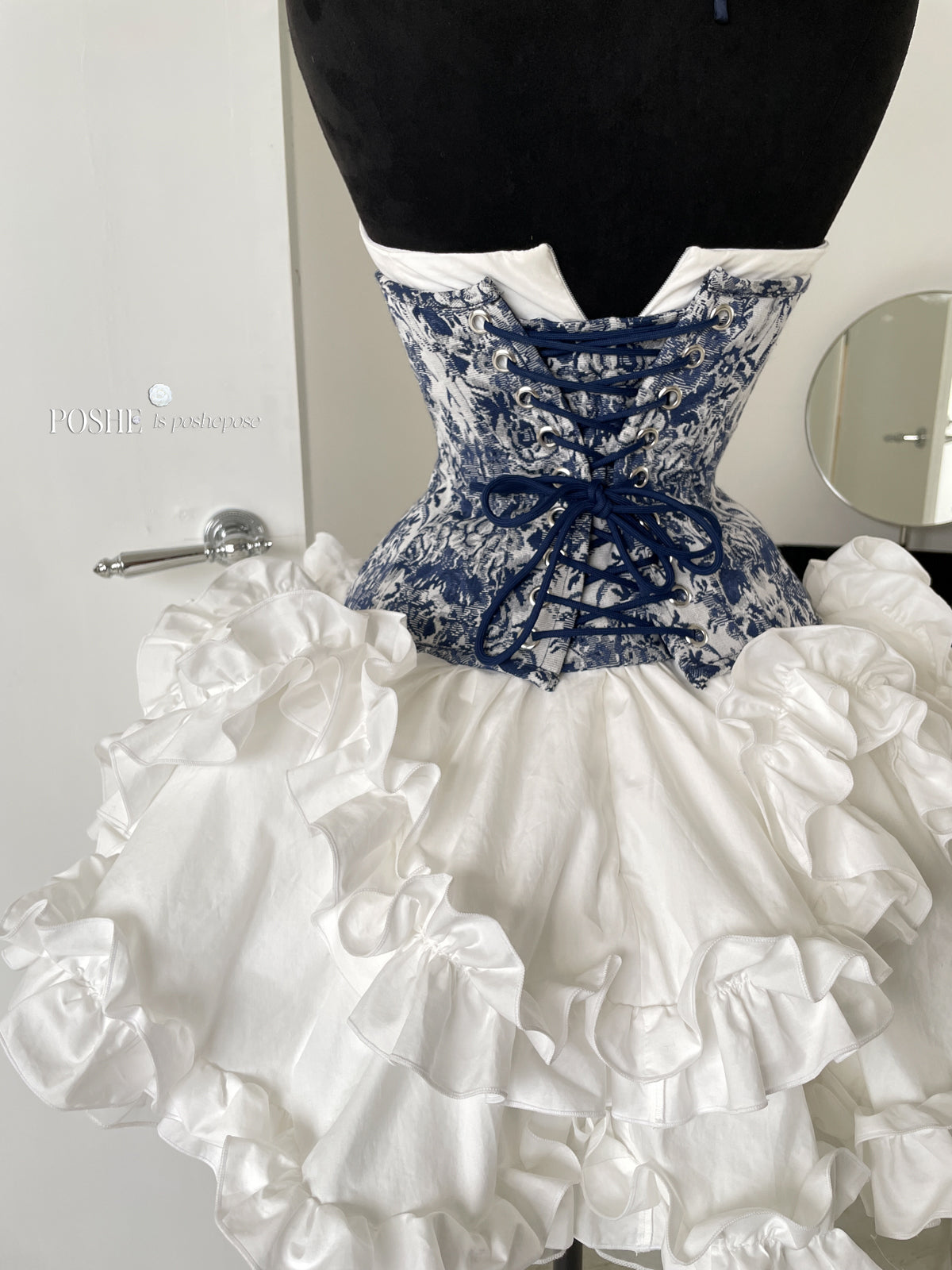 Elegant Rococo-style corset with structured bodice and vintage floral embroidery.