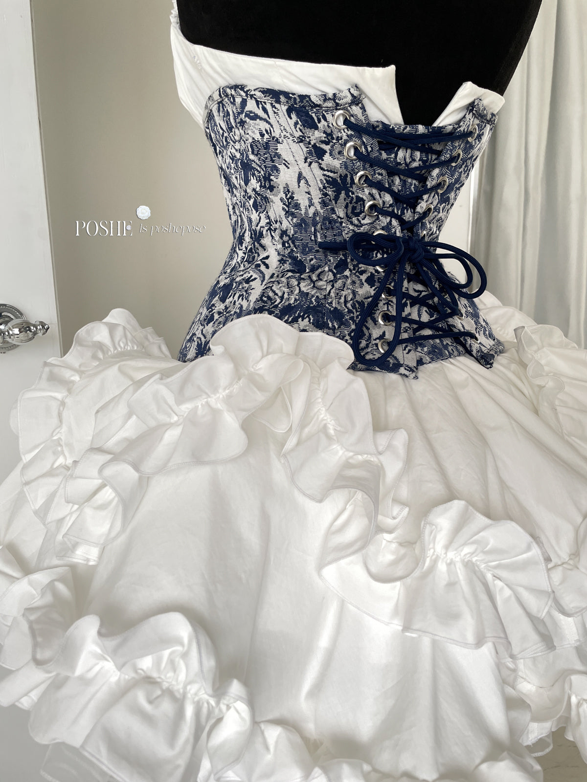 White puff-sleeve lolita corset dress with Caviar Blue floral detailing from Poshepose Global.
