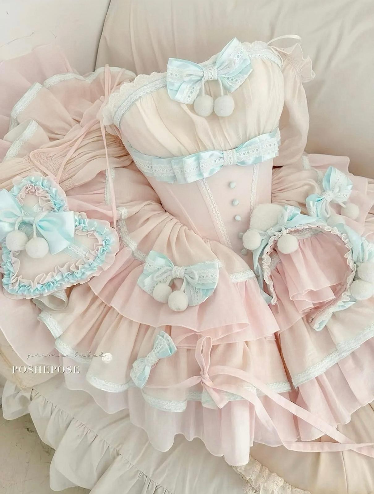 Sweet pastel pink and mint lolita dress with decorative pom-poms and satin bows.